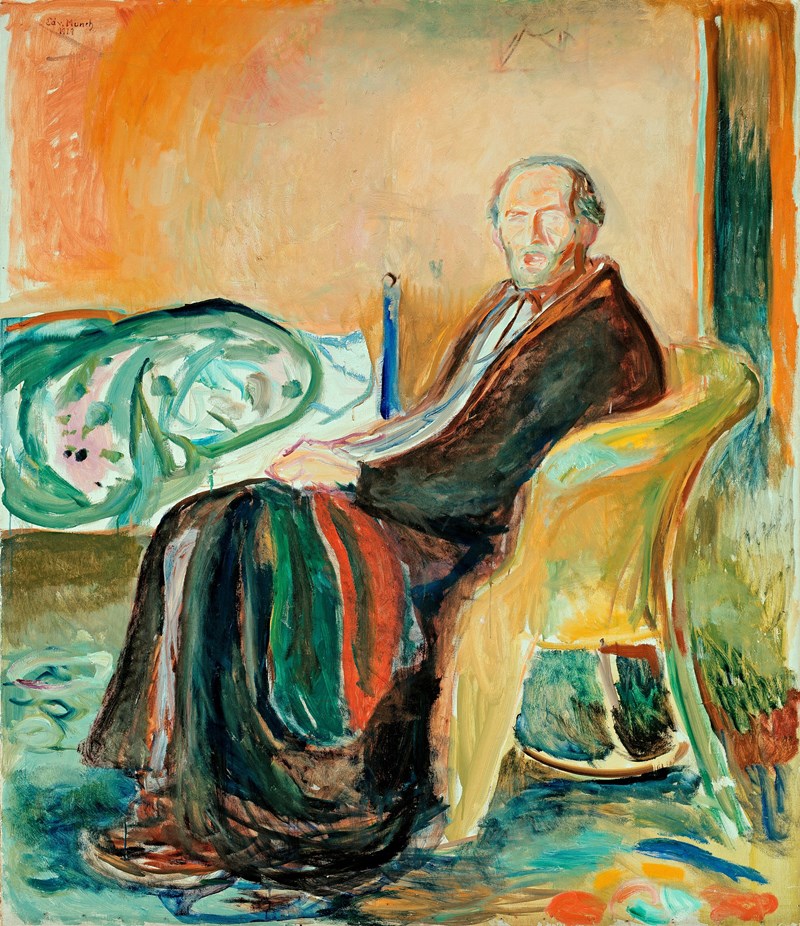 Edvard Munch sitter i en gul kurvstol med pysj og morgenkåpe, et rødt og grønt teppe i fanget. I bakgrunnen vises en uoppredd seng.